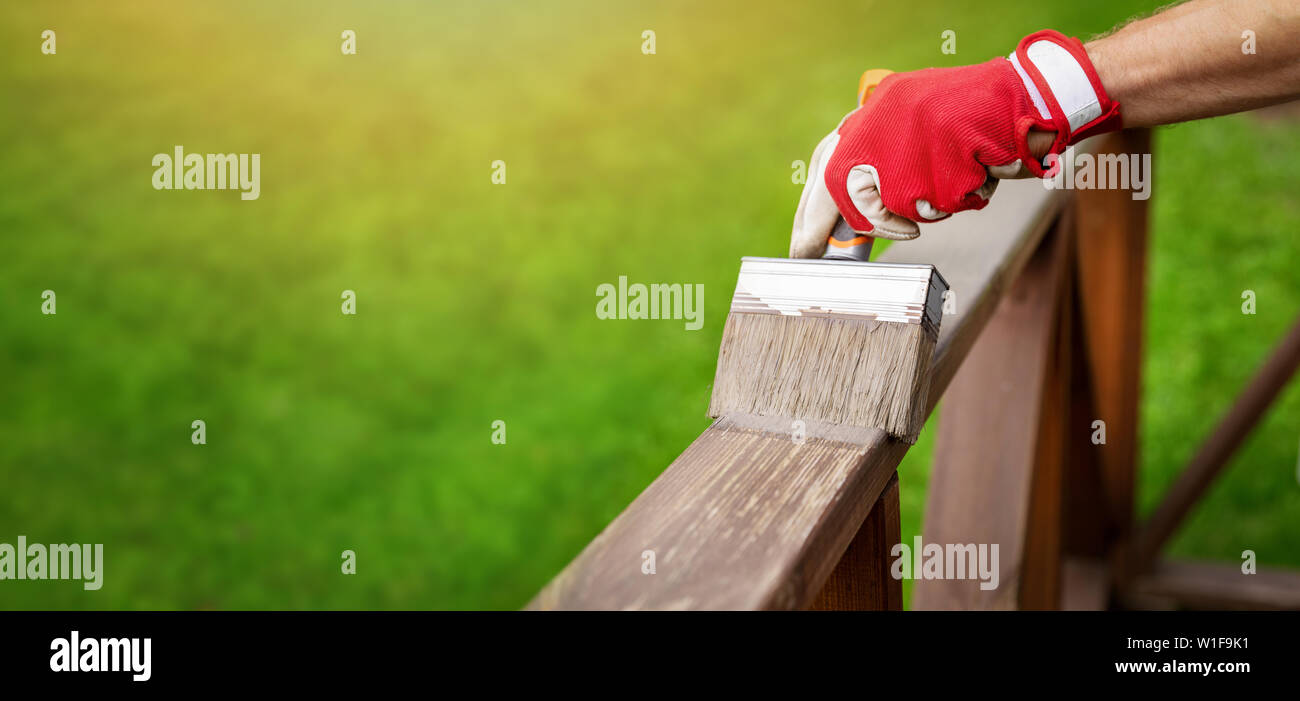 restoring wood protective paint on outdoor terrace railings. copy space Stock Photo