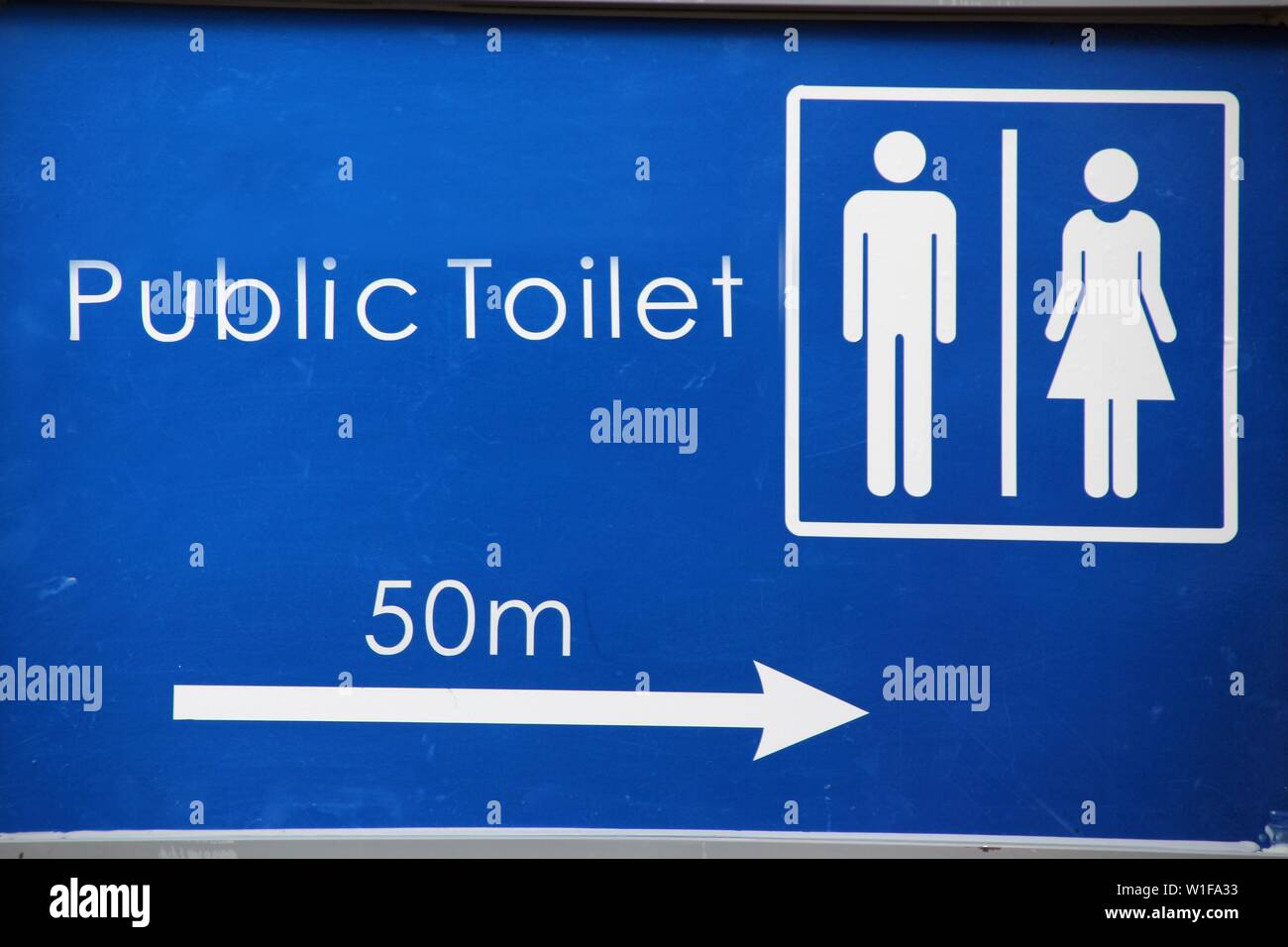 sign for a public toilet in blue Stock Photo Alamy