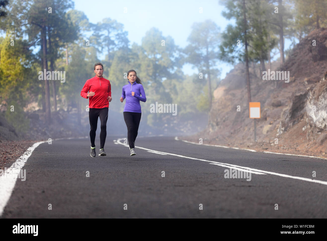 People running athlete runners training jogging in cloudy and cold