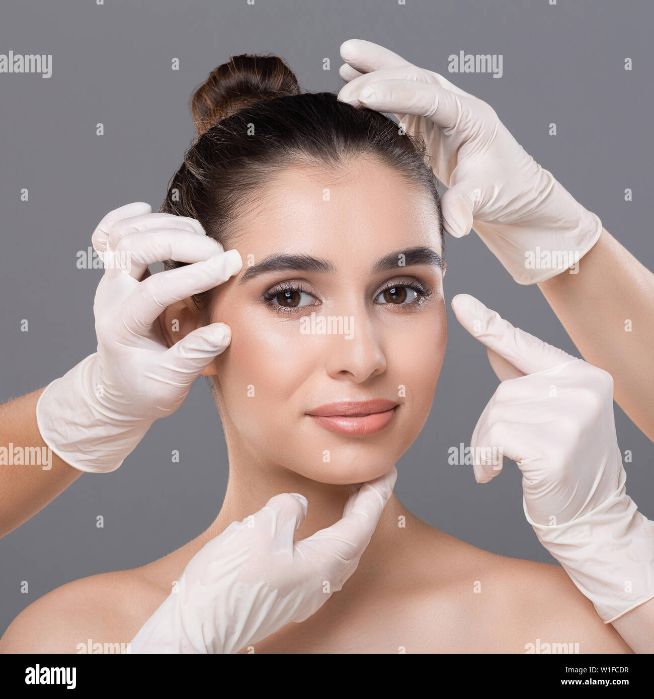 Young woman getting consultation at plastic surgery clinic Stock Photo
