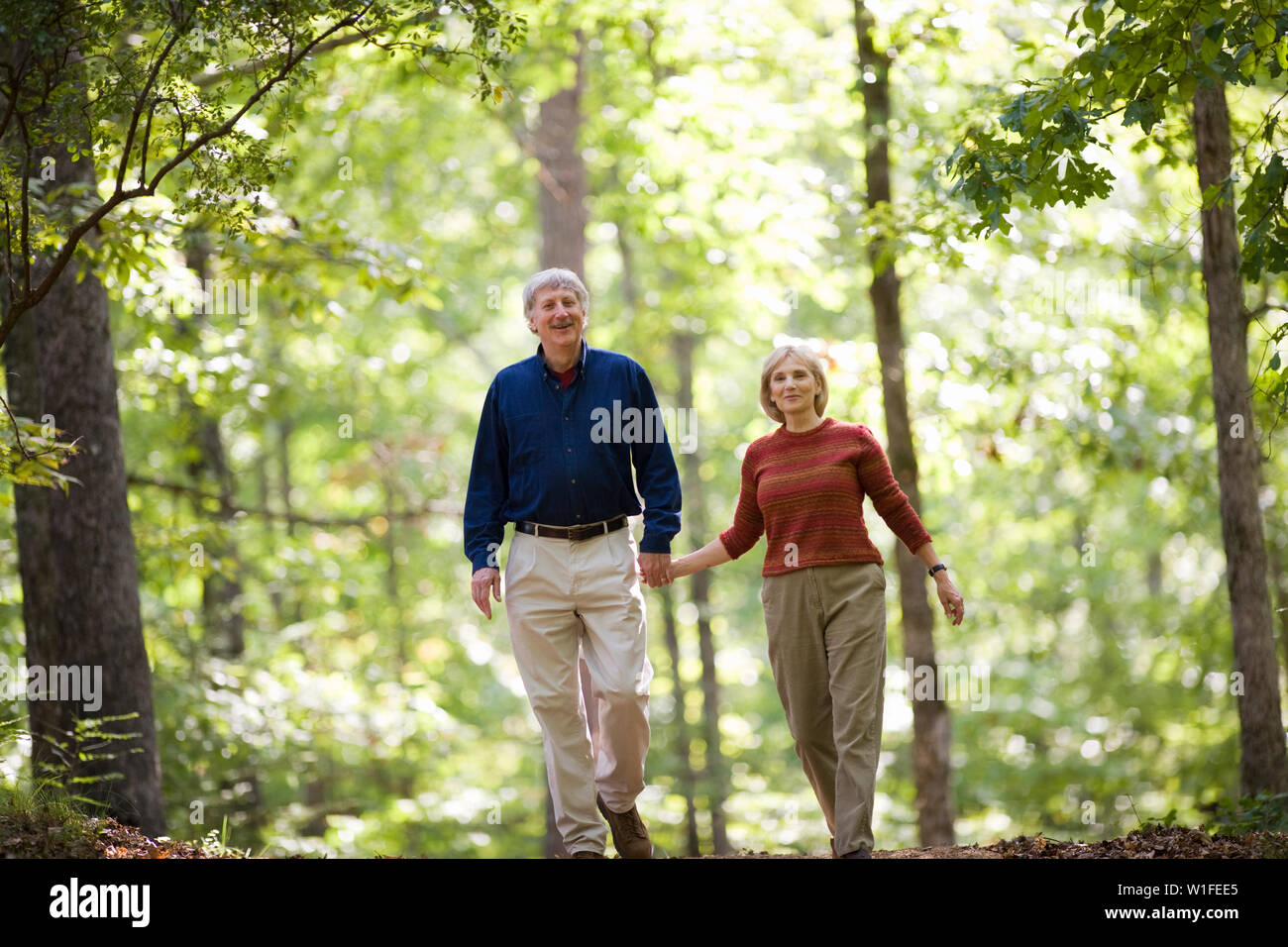 Couple going for a walk in the woods Stock Photo - Alamy
