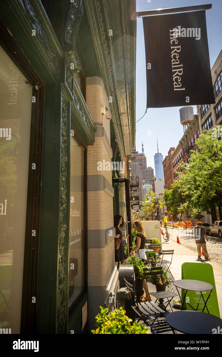 Customers leave and enter The RealReal luxury consignment store in the Soho neighborhood of New York on Wednesday, June 26, 2019. The startup, which sells after authentication previously owned luxury goods on consignment is launching its initial public offering later this week. The estimate for the total luxury resale market in the U.S. is $6 billion. (© Richard B. Levine) Stock Photo
