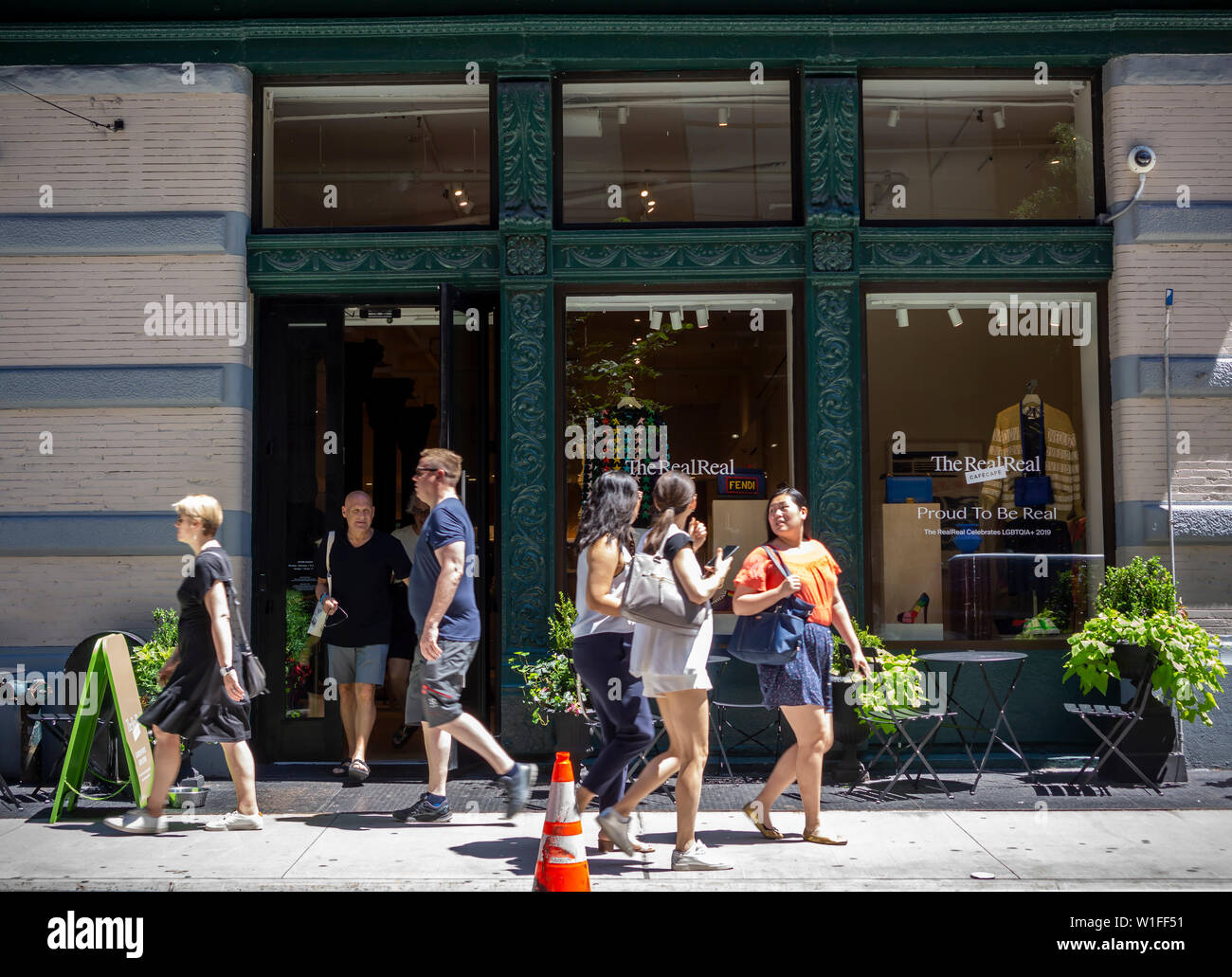 Customers leave and enter The RealReal luxury consignment store in the Soho neighborhood of New York on Wednesday, June 26, 2019. The startup, which sells after authentication previously owned luxury goods on consignment is launching its initial public offering later this week. The estimate for the total luxury resale market in the U.S. is $6 billion. (© Richard B. Levine) Stock Photo