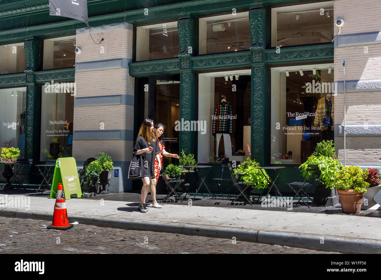 Customers leave and enter The RealReal luxury consignment store in the Soho neighborhood of New York on Wednesday, June 26, 2019. The startup, which sells after authentication previously owned luxury goods on consignment is launching its initial public offering later this week. The estimate for the total luxury resale market in the U.S. is $6 billion. (© Richard B. Levine) Stock Photo