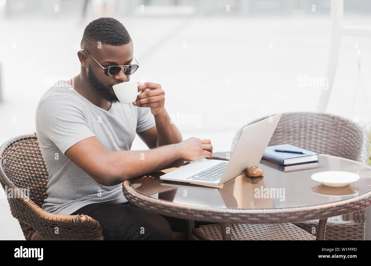 African american man reading news on laptop Stock Photo