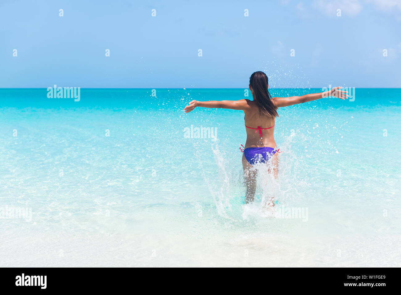 Woman running beach bikini hi-res stock photography and images - Alamy