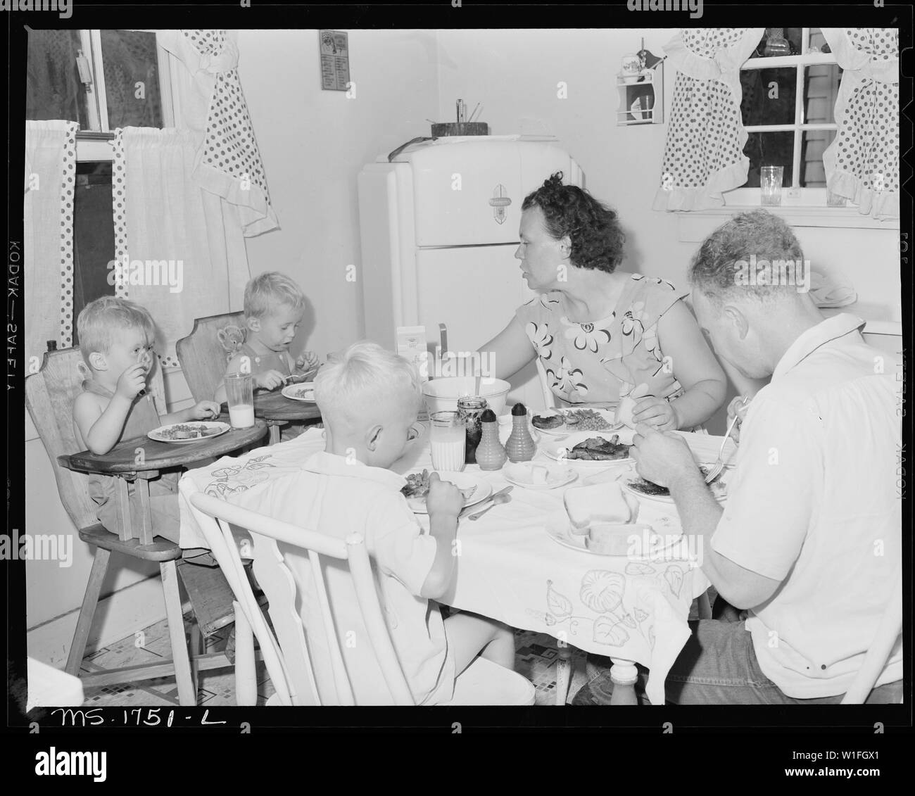 James Jasper, motor brakeman, and his family eat dinner in their kitchen in home in company housing project. Koppers Coal Division, Kopperston Mines, Kopperston, Wyoming County, West Virginia. Stock Photo