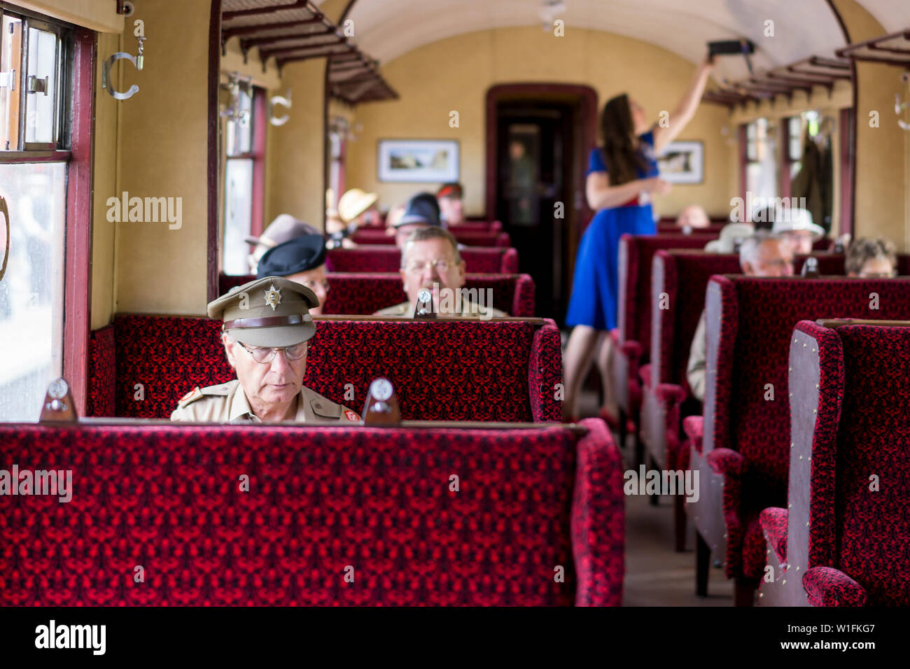 Kidderminster, UK. 29th June, 2019. Severn Valley Railways 'Step back to the 1940's' gets off to a fabulous start this summer with re-enactors playing their part in providing an authentic recreation of wartime, WW2 Britain. 1940s rail travel is shown with passengers, dressed in 1940s fashion, travelling inside one of the vintage railway carriages on this heritage railway line.  Credit: Lee Hudson Stock Photo