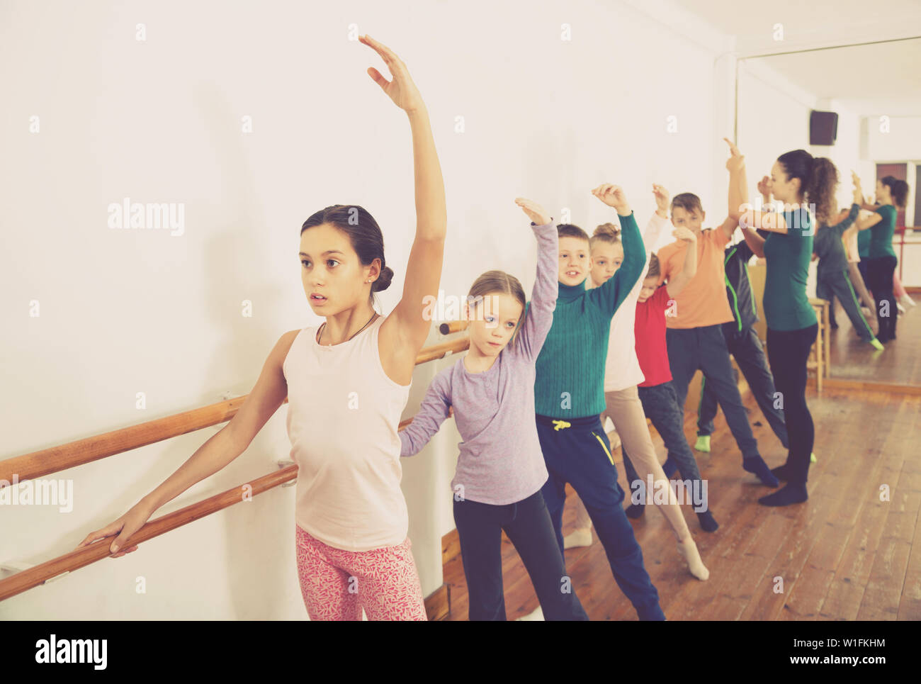 Young friendly sm ballet dancers exercising in ballroom Stock Photo - Alamy