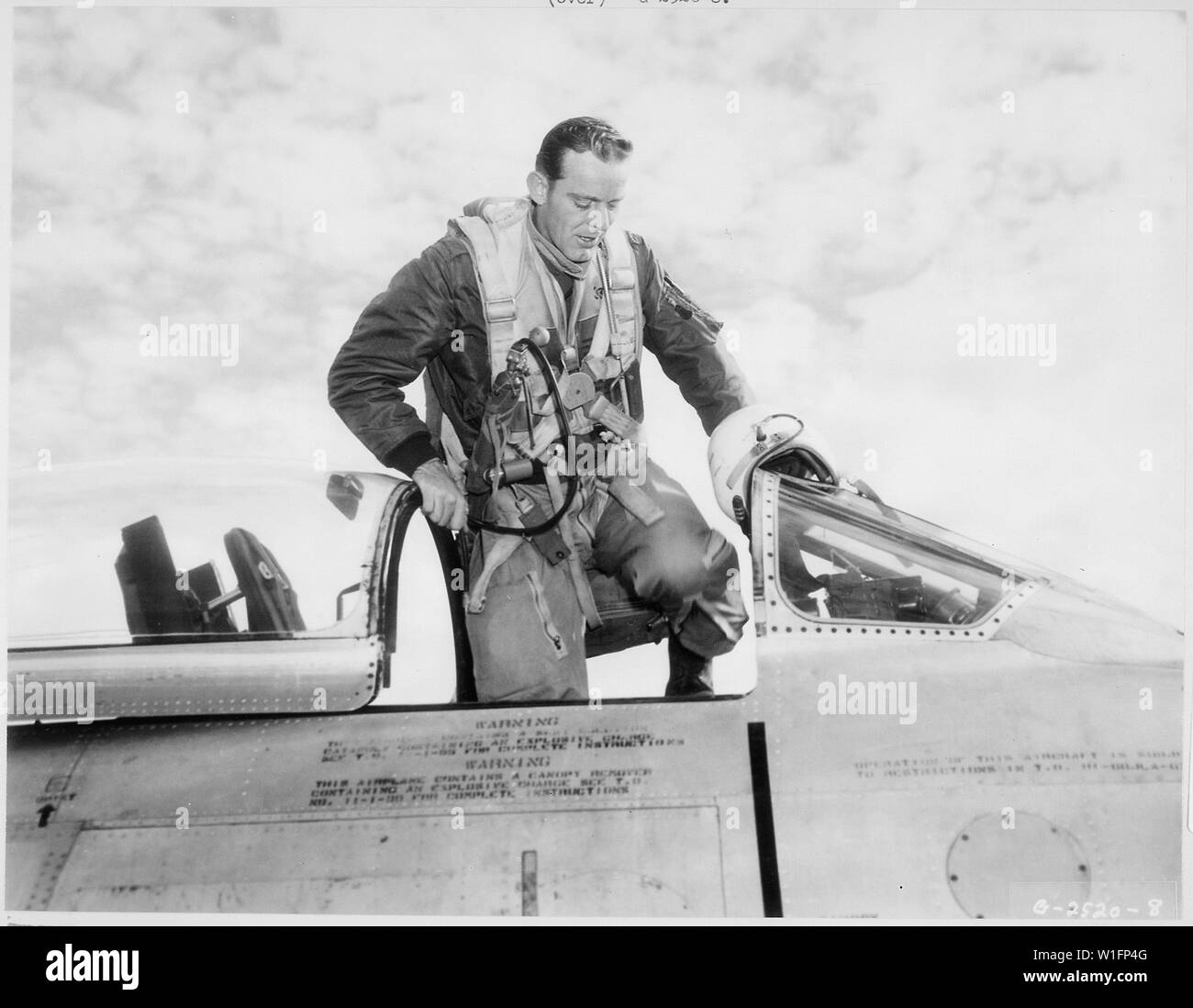 KOREA--U.S. Air Force F-86 Sabre jet pilot, Capt. Kenneth D. Critchfield, Fort Madison, Iowa, mounts to the cockpit of his deadly, swept-wing jet-fighter to make another sweep of MIG Alley, scene of many vicious duels between American Sabre jet pilots and Communist MIG-15s. Stock Photo