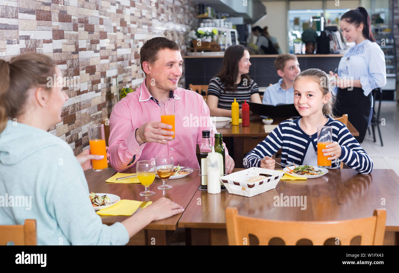 Positive spanish family with teenage children enjoying meal in cafe Stock  Photo - Alamy