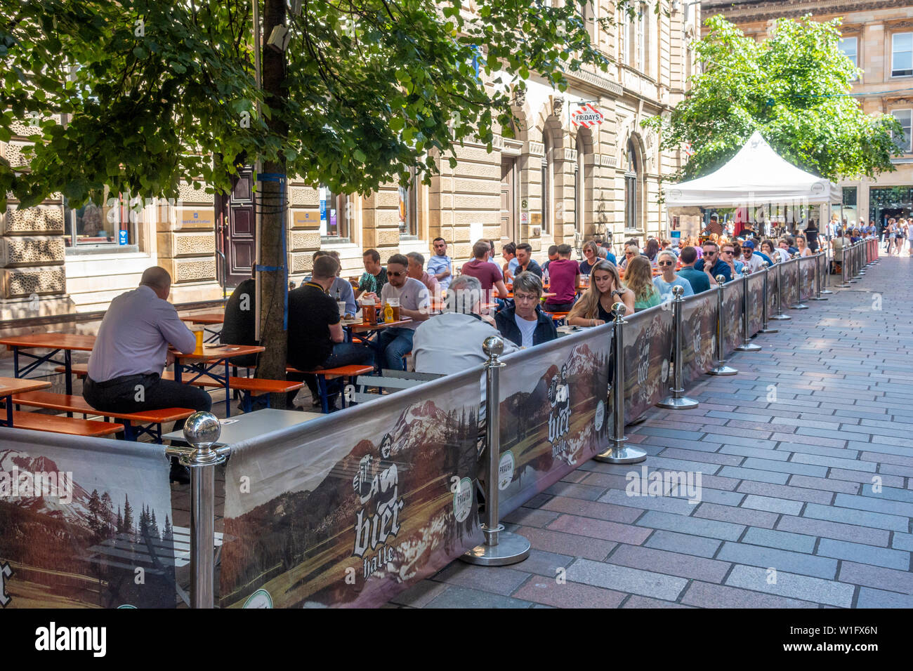 Patrons enjoying a sunny June afternoon in the Bier garten / beer garden / outdoor seated area of the Bier Halle, Gordon Street, Glasgow, Scotland Stock Photo