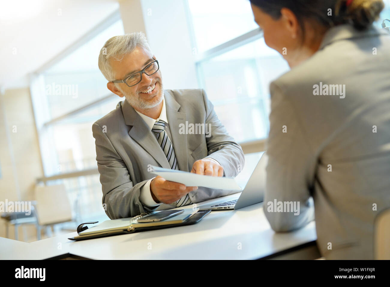 Coporate meeting between executive and employee Stock Photo