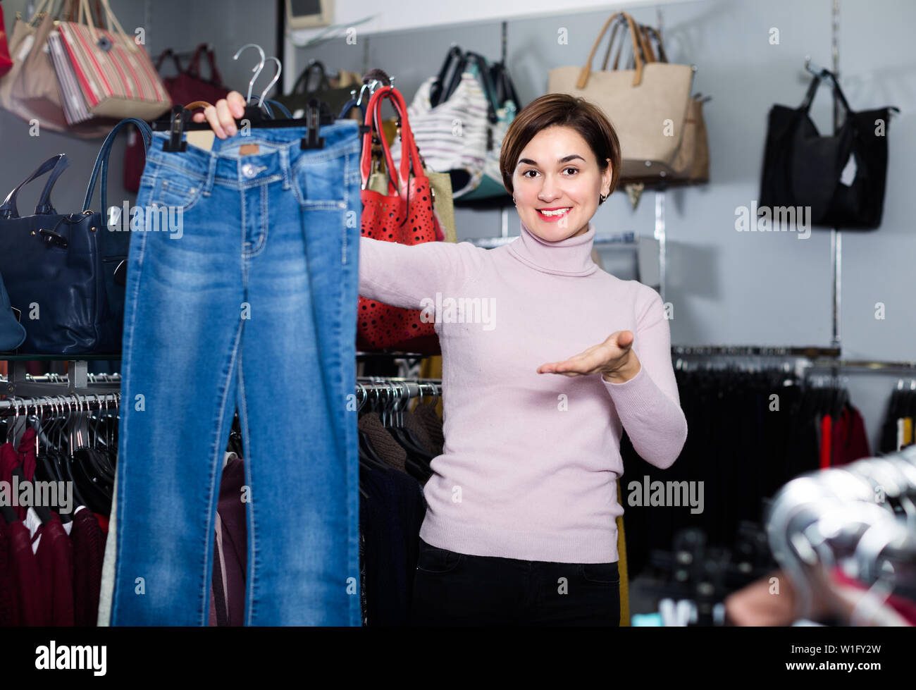 Adult Is Choosing Comfortable Jeans In Women S Cloths Shop Stock