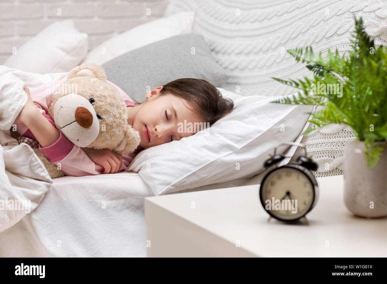 Cute little child girl sleeping with teddy bear in her bed Stock Photo ...