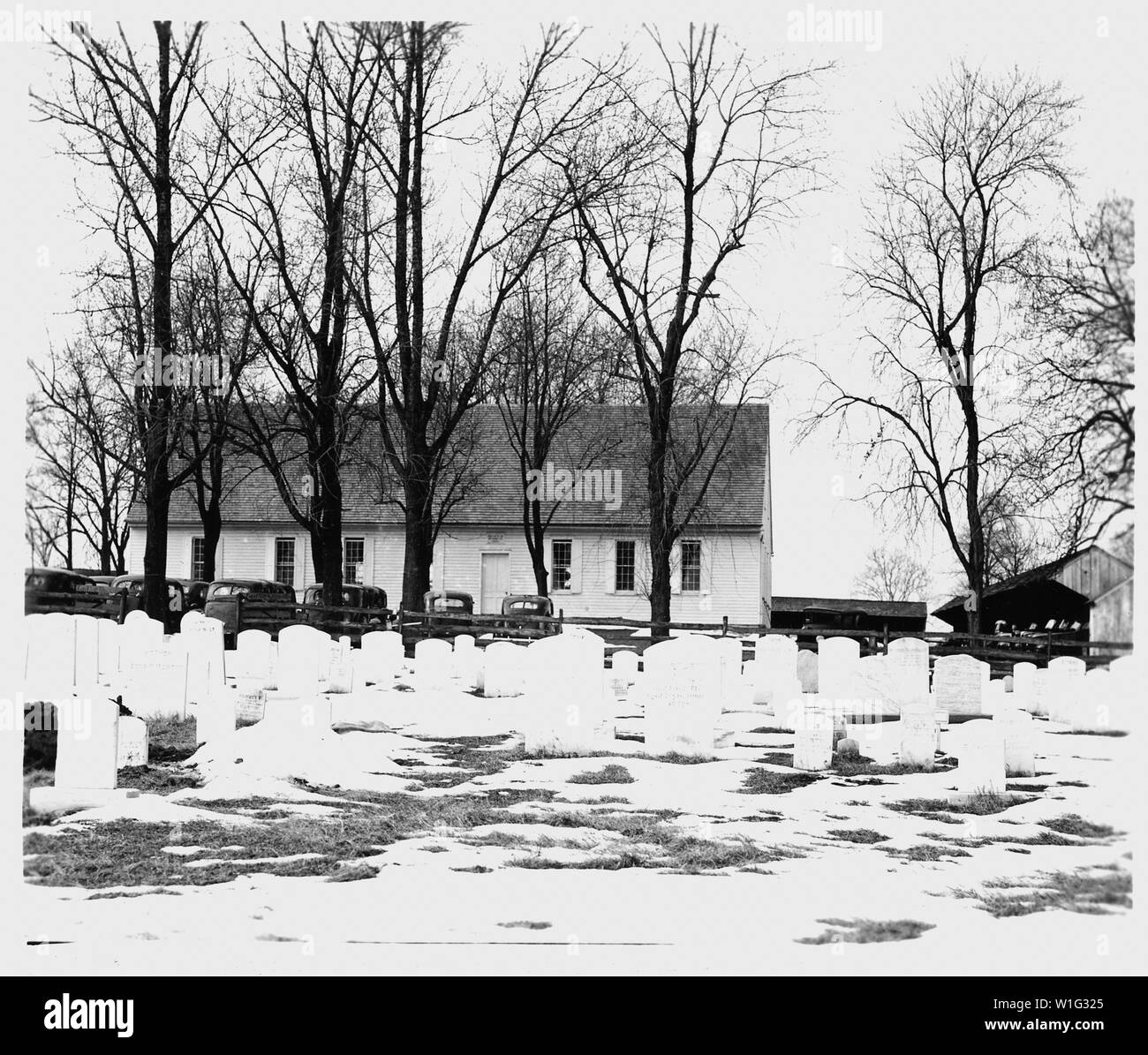 Lancaster County, Pennsylvania. Meeting house of the Weaverland Conference Mennonites near New Holl . . .; Scope and content:  Full caption reads as follows: Lancaster County, Pennsylvania. Meeting house of the Weaverland Conference Mennonites near New Holland. The auto-owning and autoless members worship in this meeting house on alternate Sundays. Like Quaker meeting houses, those of the Mennonites do not have steeples, colored windows, or any musical instruments within the building. Tombstones like those of the Amish, must bear a simple inscription Stock Photo