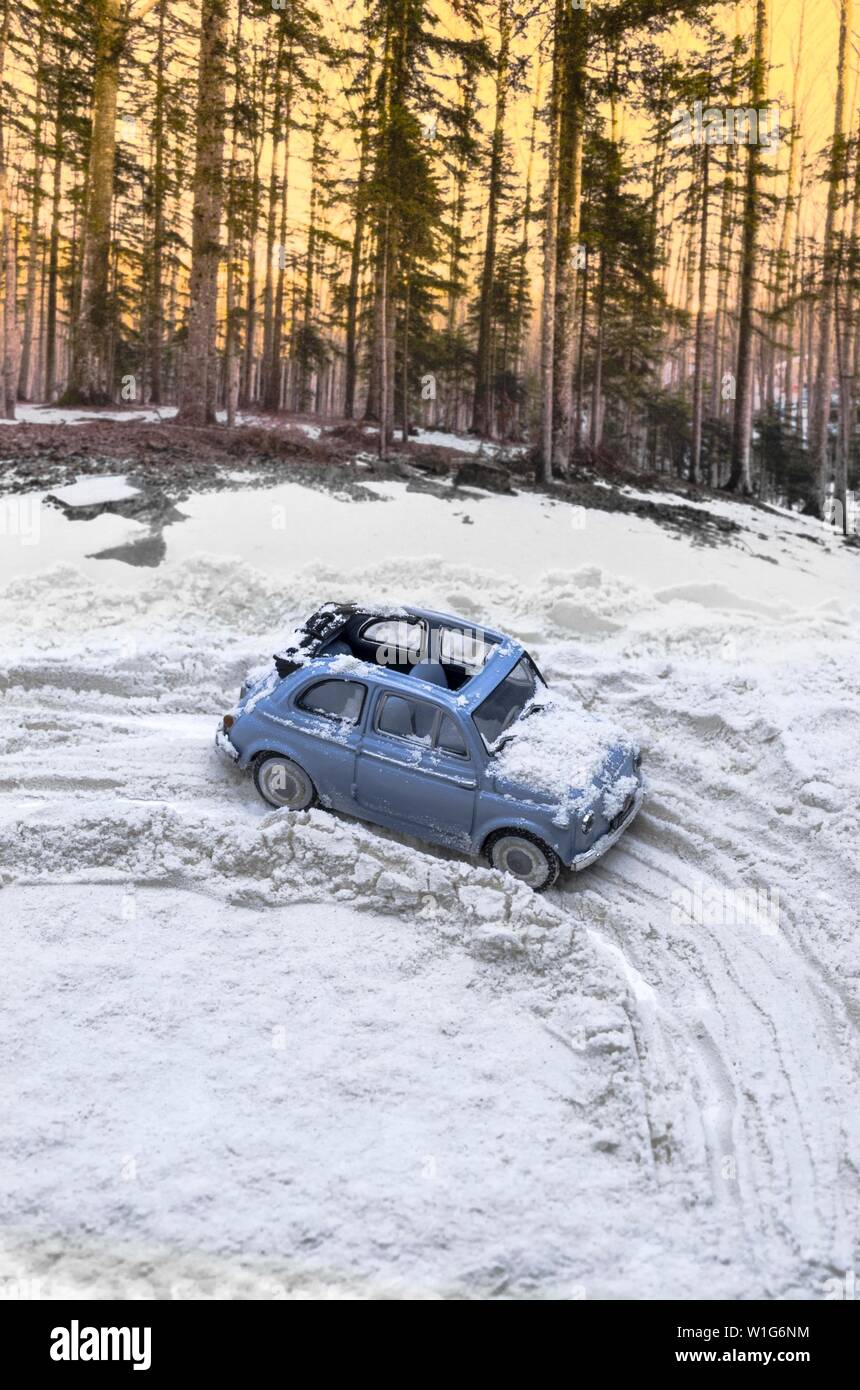 Diorama - Vintage car on snow-covered mountain road Stock Photo