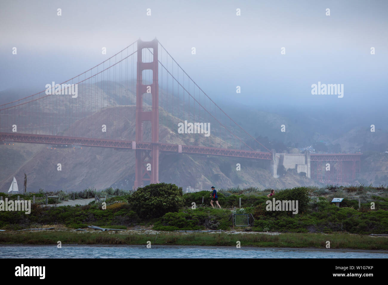 Man running near Golden Gate bridge taken from Marina Boulevard in San Francisco, California, USA Stock Photo
