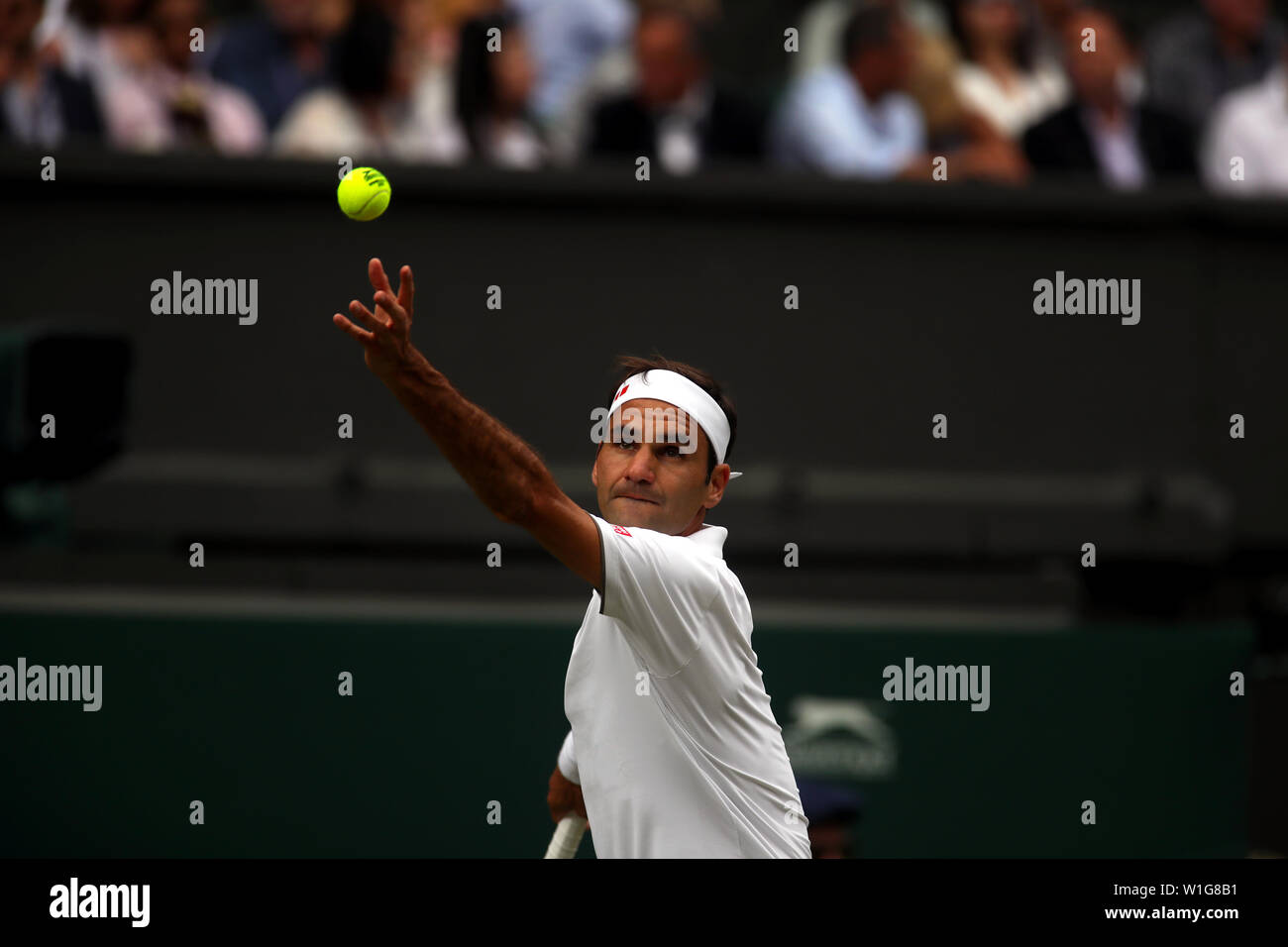 London, UK. 02nd July, 2019. Wimbledon, 2 July 2019 - Roger Federer serving during his first round match on Center Court at Wimbledon on Tuesday.  Credit: Adam Stoltman/Alamy Live News Stock Photo