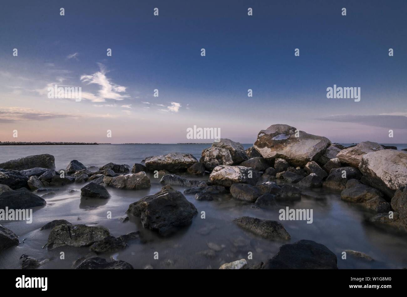 Beautiful coastal seascape with rocks in the foreground at sunset Stock ...