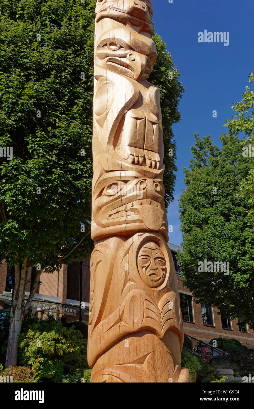 Detail of new Kwakiutl style Reconciliation totem pole carved by Xwalacktun and James Harry outside the Vancouver School Board building, Vancouver, BC Stock Photo