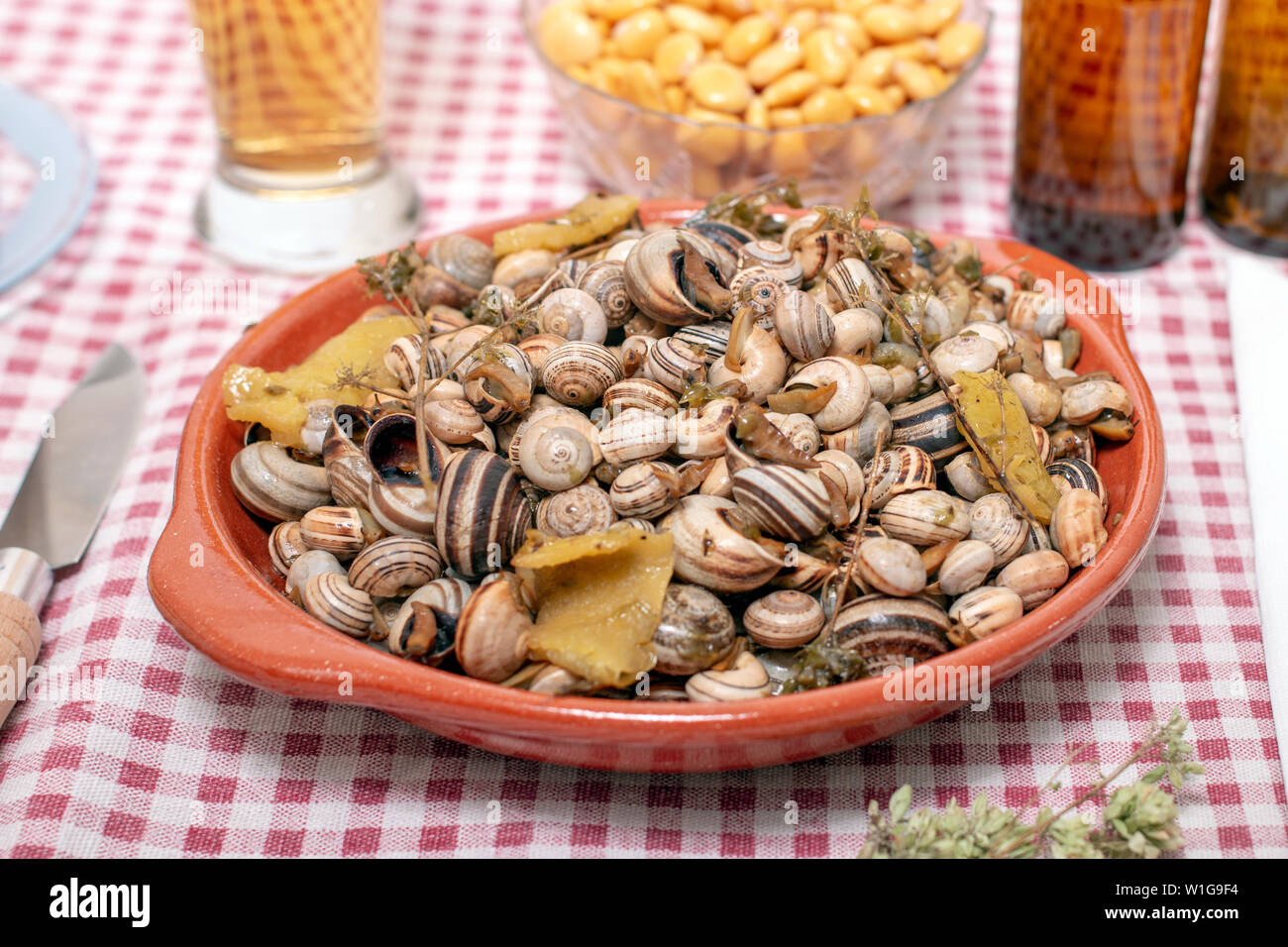 Traditional Portuguese dish of cooked snails and toasted bread and beer