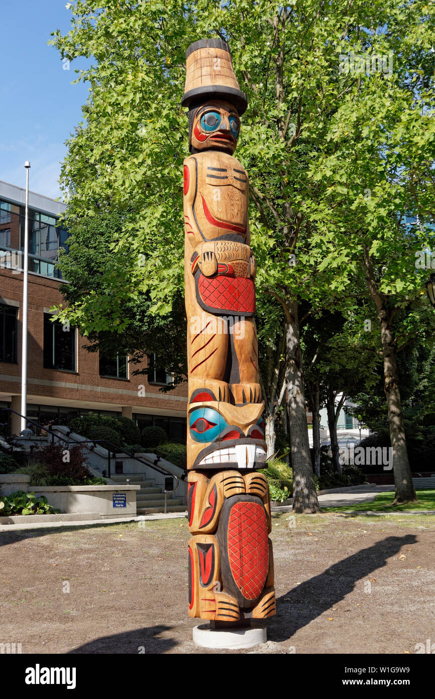 Colorful new Coast Salish style Welcome Post outside the Vancouver School Board building, Vancouver, BC, Canada Stock Photo