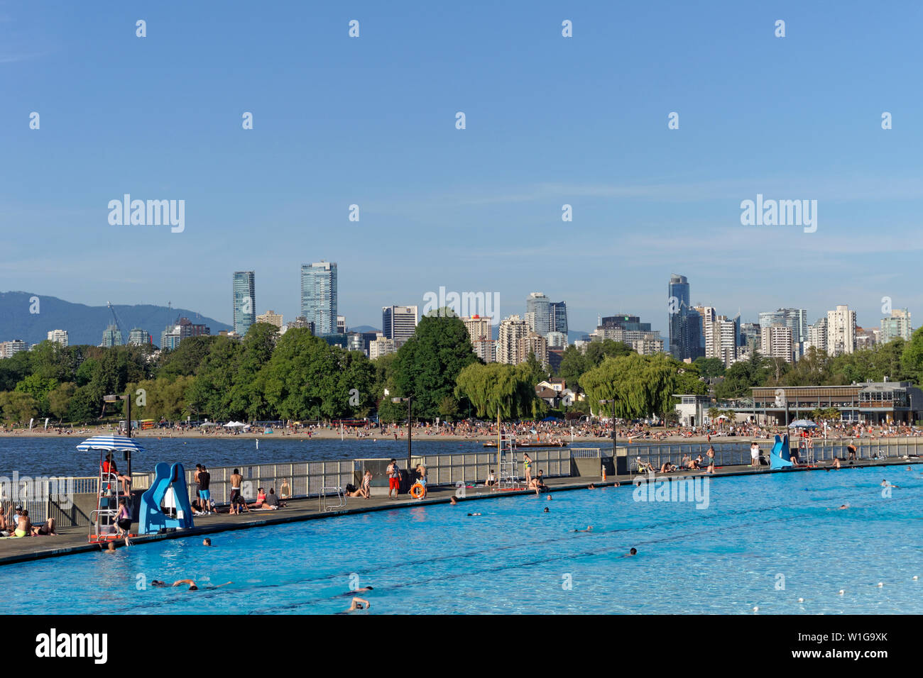 People swimming at Kitsilano Pool on English Bay with Kits Beach and the city skyline in background, Vancouver, British Columbia, Canada Stock Photo