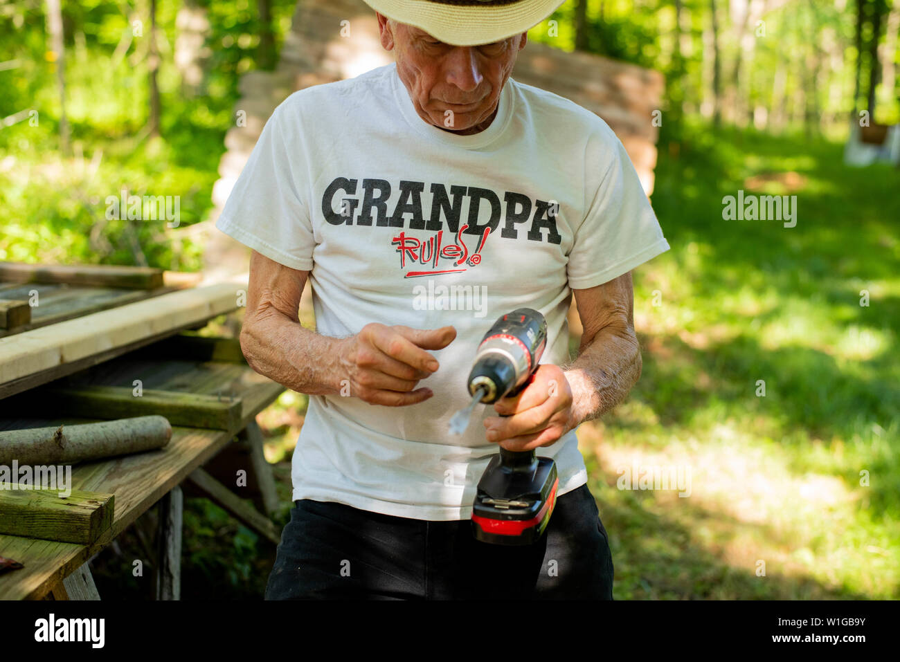 A man holds a drill during a home improvement do it yourself project. Stock Photo