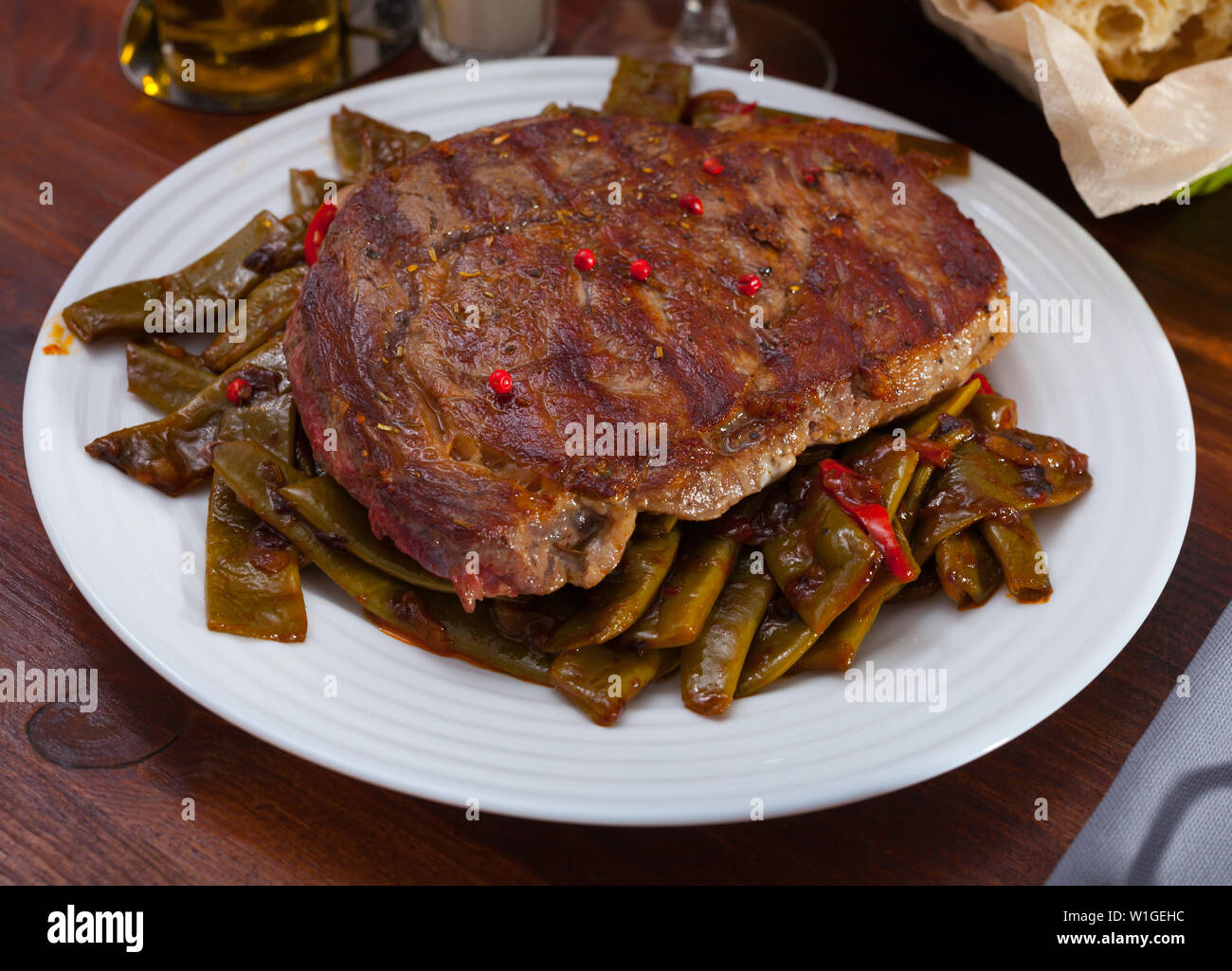 Delicious fried beef entrecote served with vegetable garnish of stewed