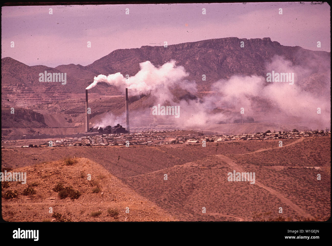 MINING TOWN OF MORENCI IS HALF HIDDEN BY SMOKE OF SMELTER STACKS. THE COPPER MINES ARE OWNED BY