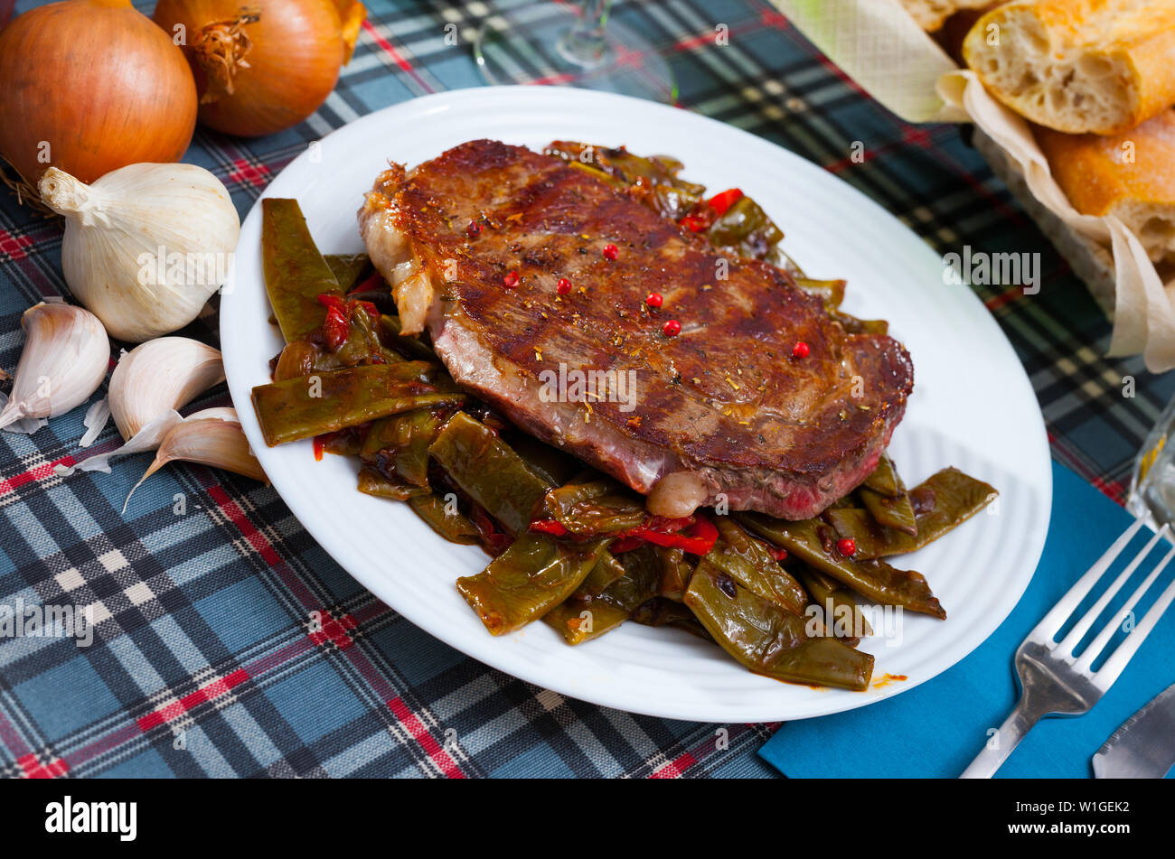 Delicious fried beef entrecote served with vegetable garnish of stewed