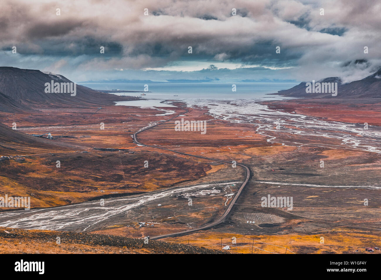 View over beautiful Adventdalen from above coal mine number 7, cloudy day in the arctic tundra of Svalbard or Spitsbergen, northern Norway Stock Photo