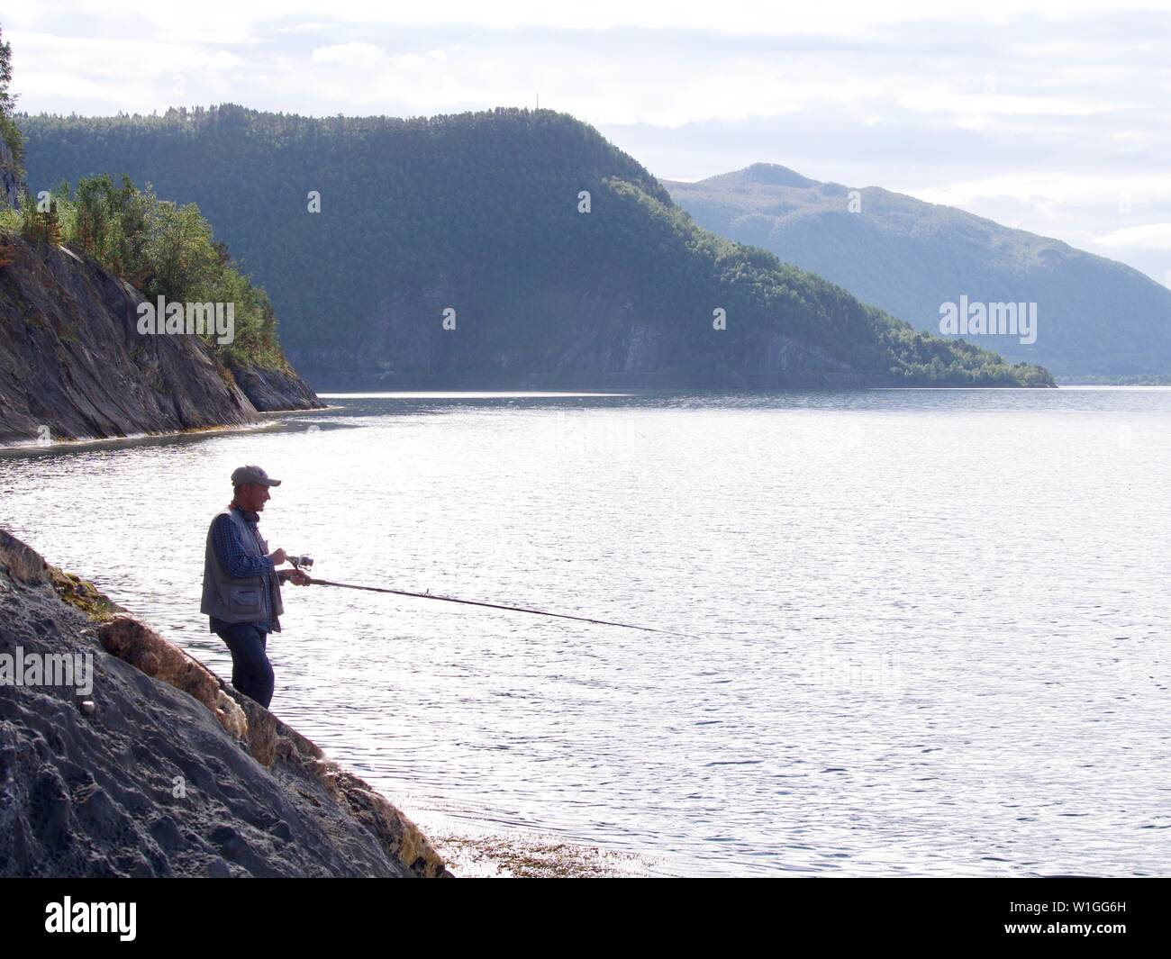 A fishing lure and fishing rod tip ready for action in the Hardanger Fjord,  norway Stock Photo - Alamy