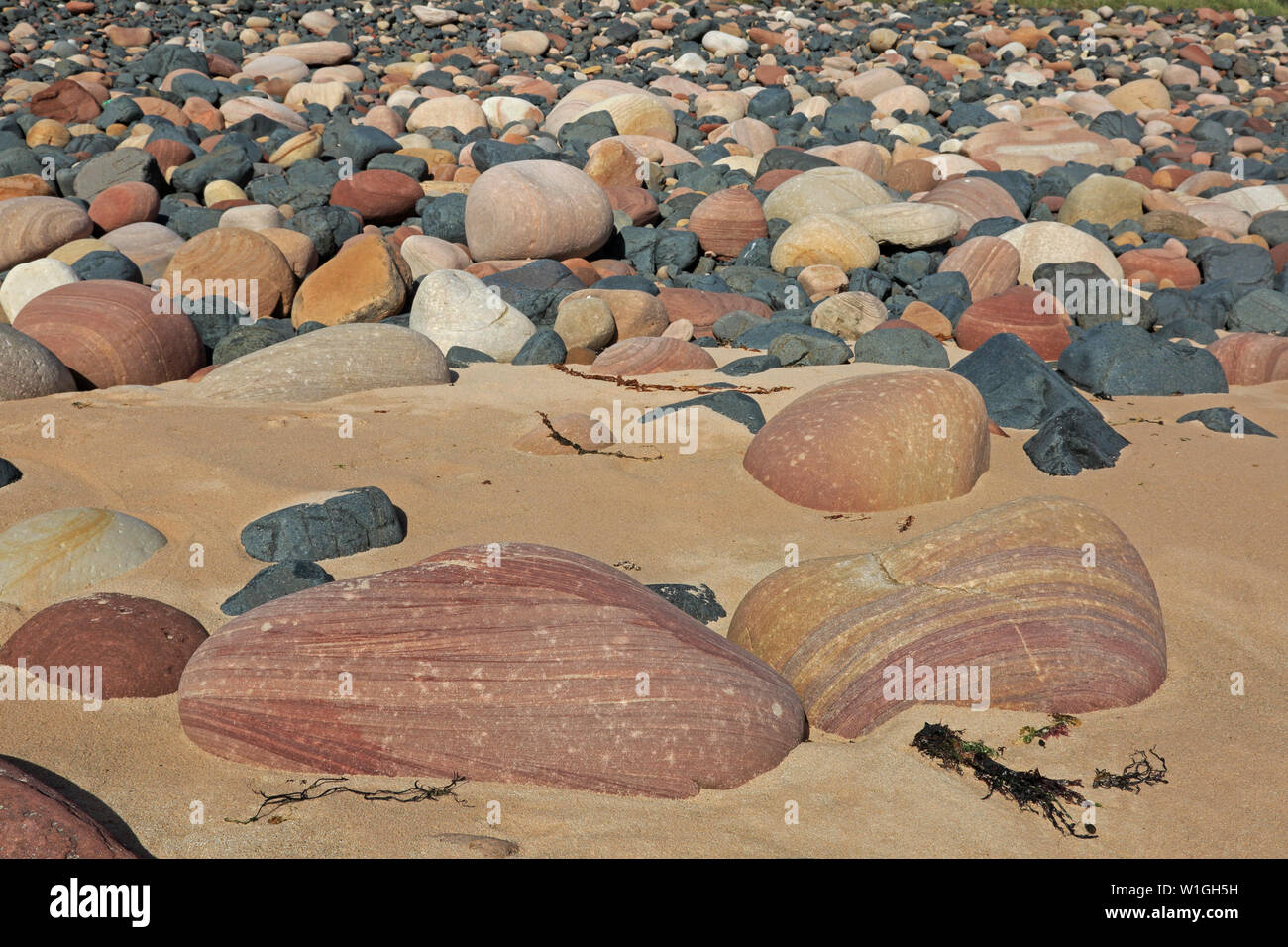Coloured and Patterned rocks on Rackwick beach Hoy Orkney Scotland Stock Photo