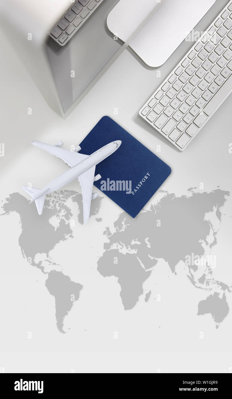 booking and search flight ticket air international travel concept, computer,passport and airplane isolated on desk background with global map Stock Photo