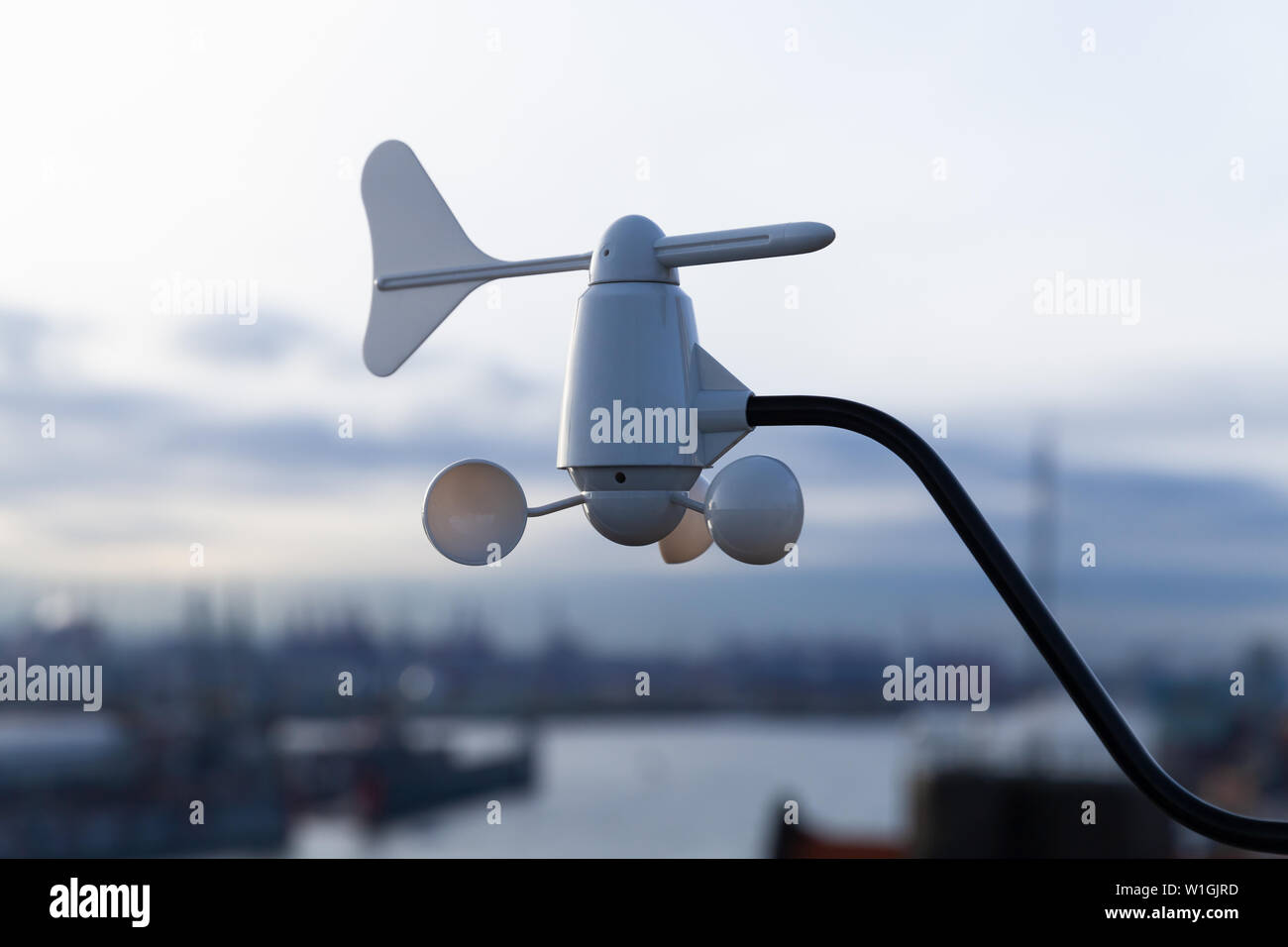 Hemispherical cup anemometer with vane mounted on a rooftop of a port