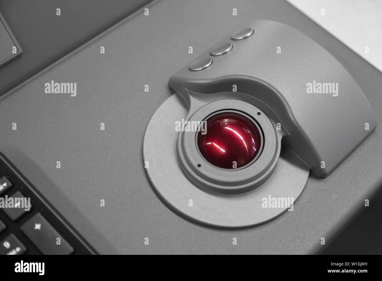 Industrial control panel made of gray steel with red trackball, close up photo with soft selective focus Stock Photo
