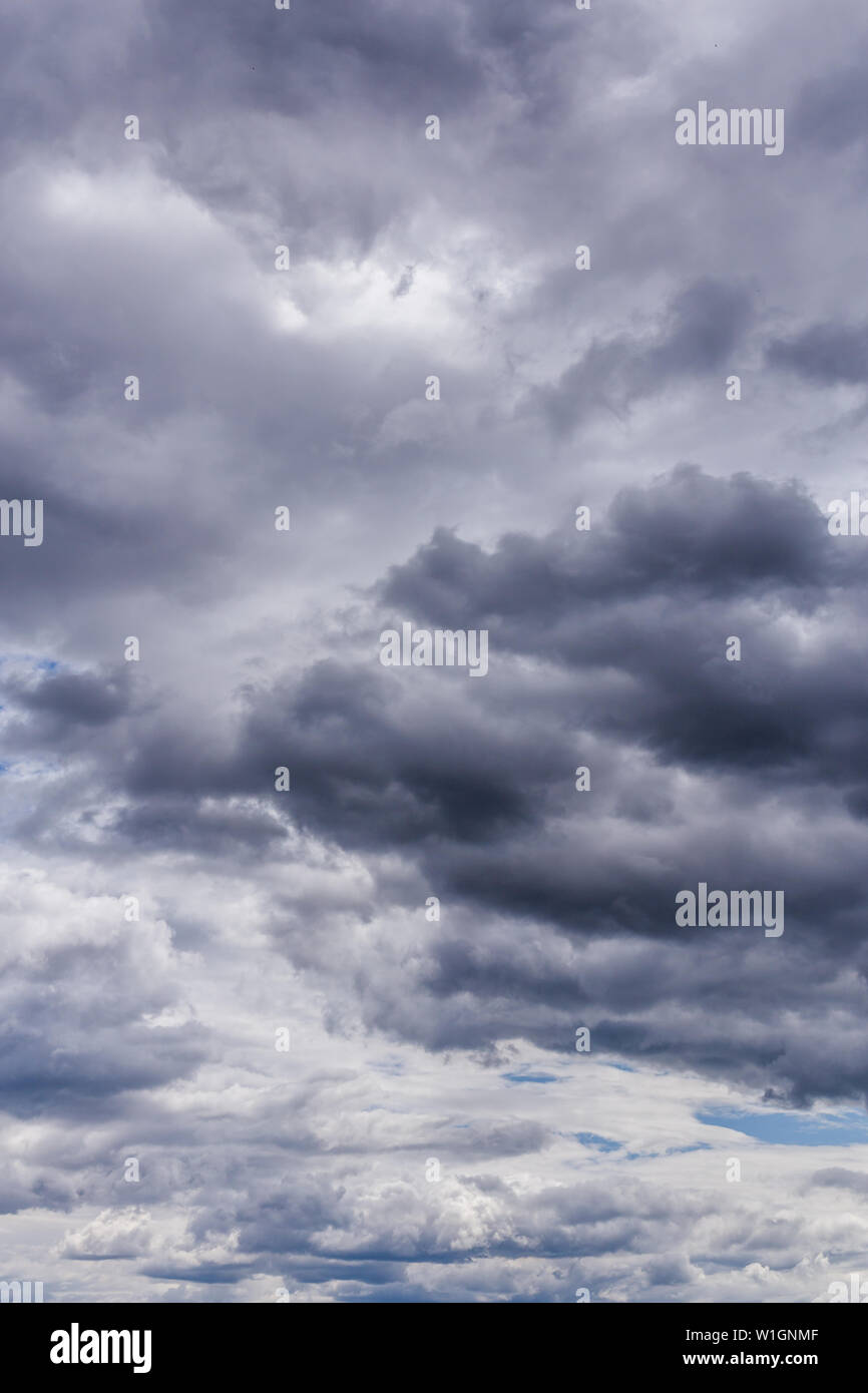 gray incoming near storm clouds daylight backdrop. Stock Photo