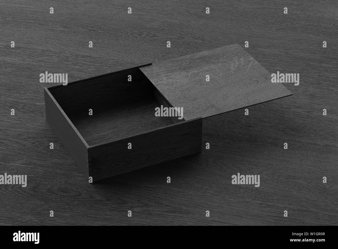 Black opened wooden square box with sliding lid on black wooden