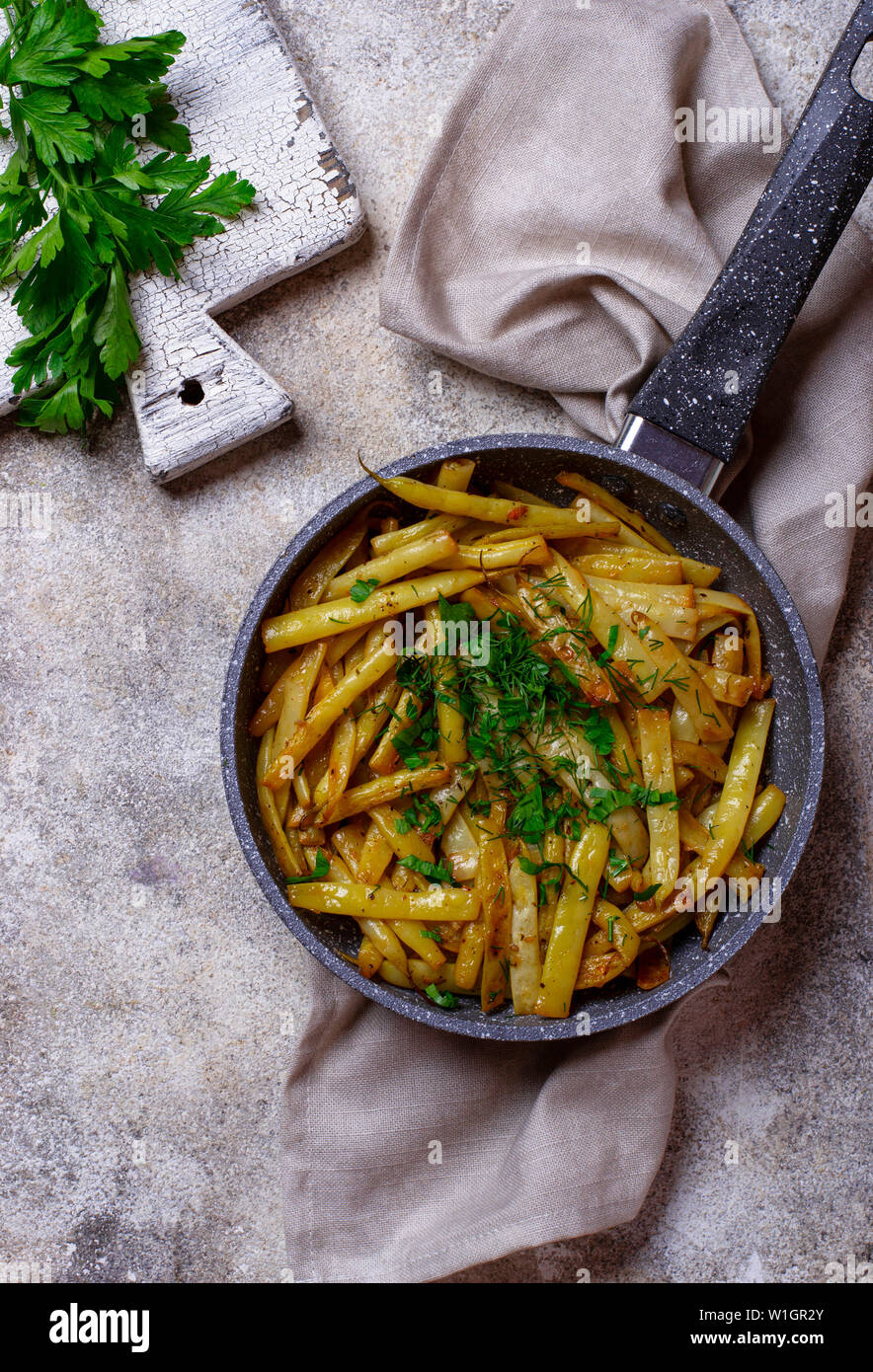 Stewed yellow wax beans in pan Stock Photo