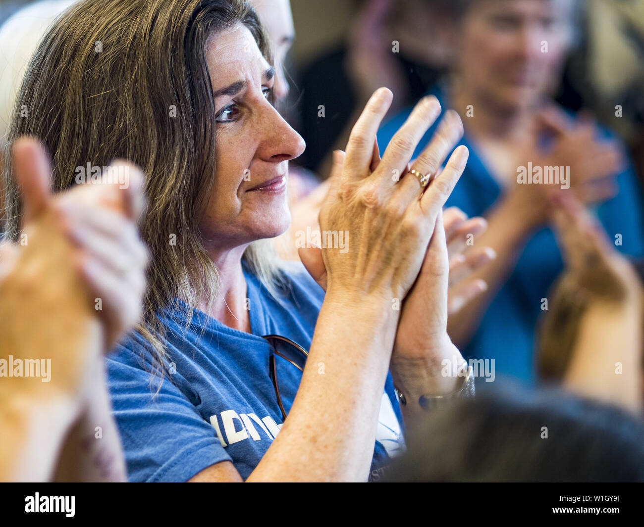 July 2, 2019 - Des Moines, Iowa, U.S - People applaud at the end of a protest in Rep. Cindy Axne's office. About 150 people came to Congresswoman Axne's office in Des Moines Tuesday to protest the treatment of migrant children detained by the US Border Patrol along the US/Mexico border. Axne was not in the office, but a member of Axne's staff took notes and promised to pass people's concerns on to the Congresswoman. Similar protests were held at other congressional offices and Immigration and Customs Enforcement (ICE) detention facilities across the country. (Credit Image: © Jack Kurtz/ZUMA Wi Stock Photo