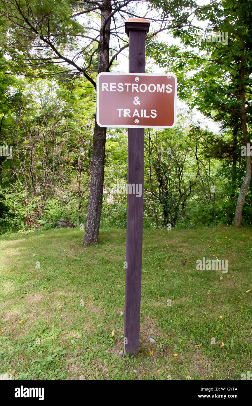 A sign at an American park showing where the restrooms and trails are located. Stock Photo