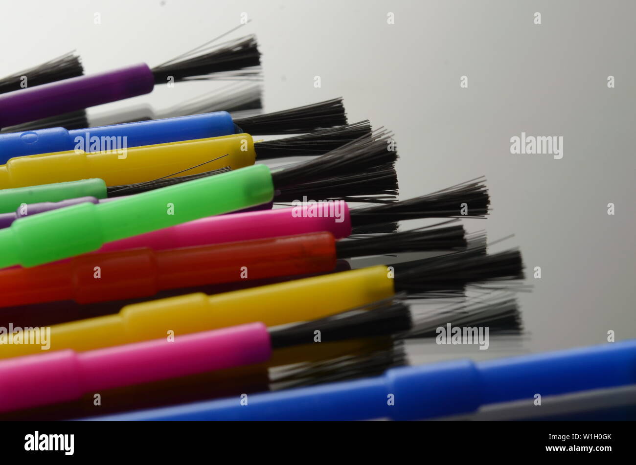 COLORING BOOK A rainbow colored assortment of paint brushes Stock Photo