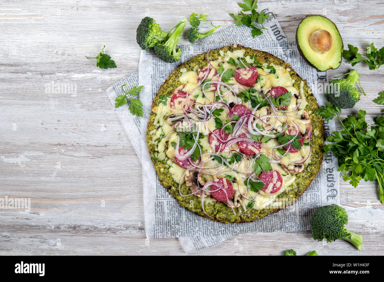 Crust Broccoli base low carbs keto pizza with salami, avocado on