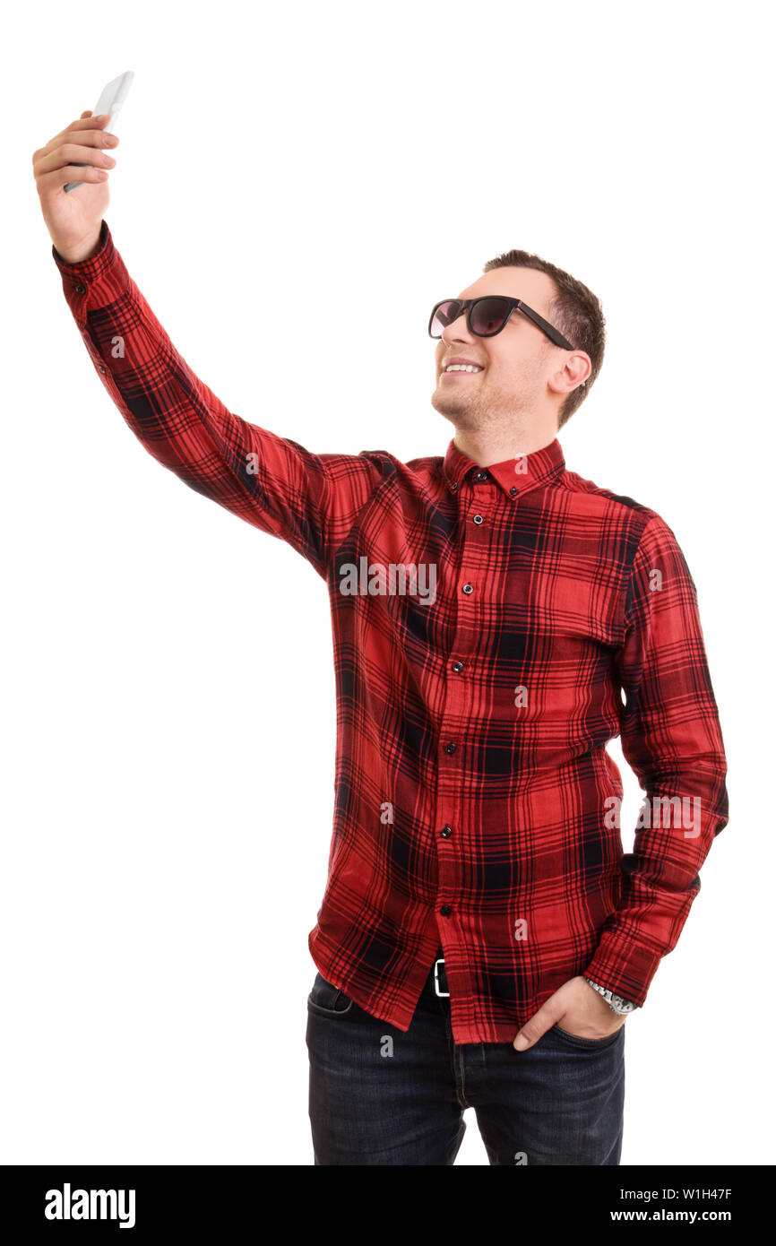 A portrait of a fashionable young man taking a selfie, isolated on white background. Stock Photo