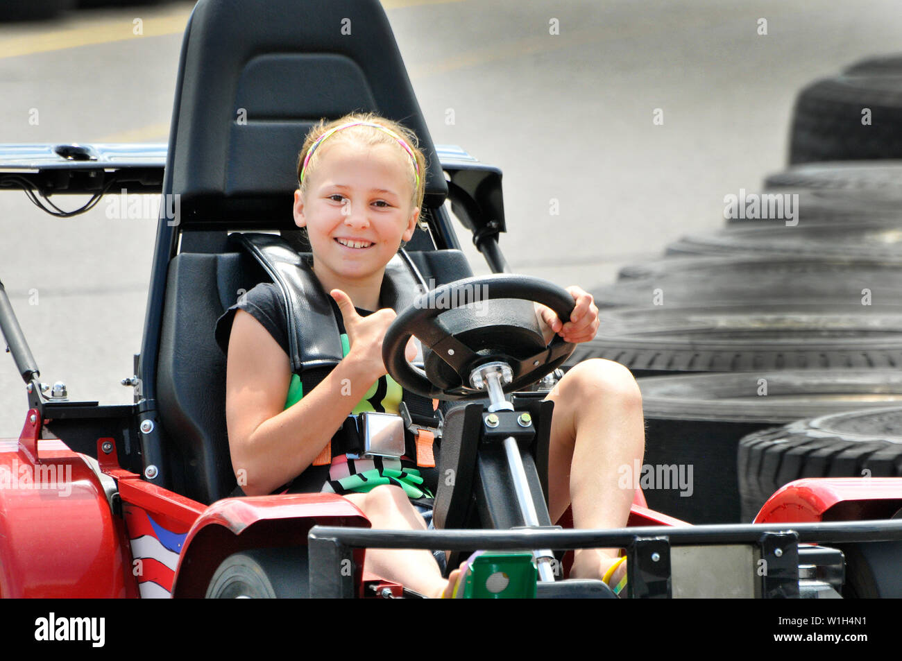 Go kart driver Abbi gives thumbs up through the chicane on the track in