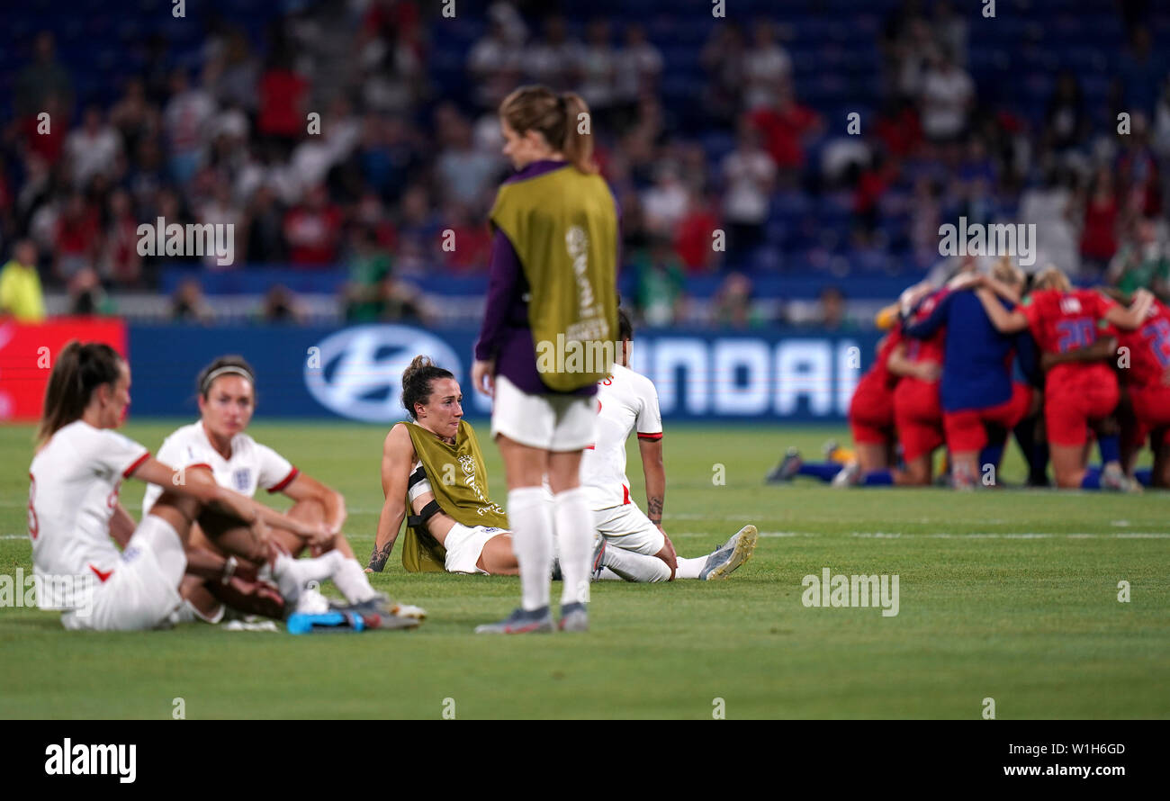 England players appear dejected and the United States team (right) celebrate after the final whistle during the FIFA Women's World Cup Semi Final match at the Stade de Lyon. Stock Photo