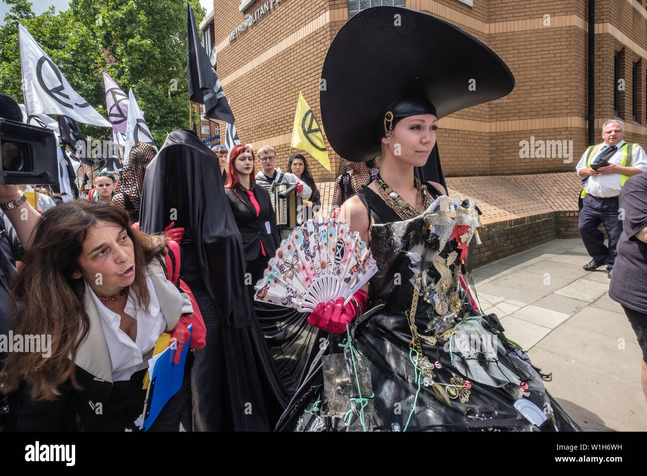 London, UK. 2nd July 2019. A procession by Extinction Rebellion, led by Carmen, marches towards the next venue in their performances outside offices oil companies in the Oil and Gas Climate Initiative (OGCI) urging them to abandon the pretence they can combat global warming without a huge cut in oil production. The protest on the day that BP were sponsoring a Royal Opera House performance of Carmen to be relayed to 13 BP big screens starred Carmen speaking, a fine opera singer and XR drummers and a team marking the companies as crime scenes. Peter Marshall/Alamy Live News Stock Photo