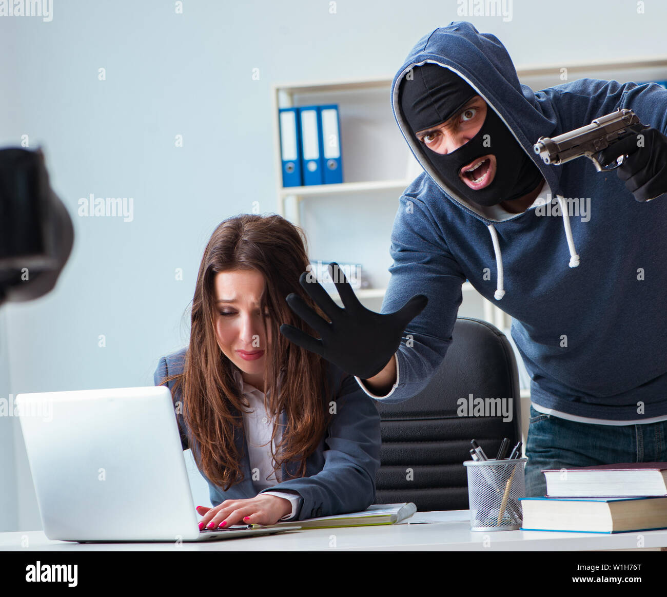 Criminal taking businesswoman as hostage in office Stock Photo - Alamy
